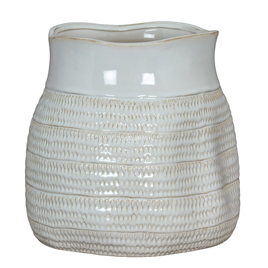 White ceramic pitcher with textured design on a white background