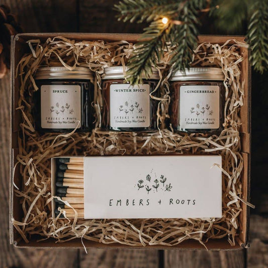 Open Embers & Roots gift box with three mini soy candles and a box of matches