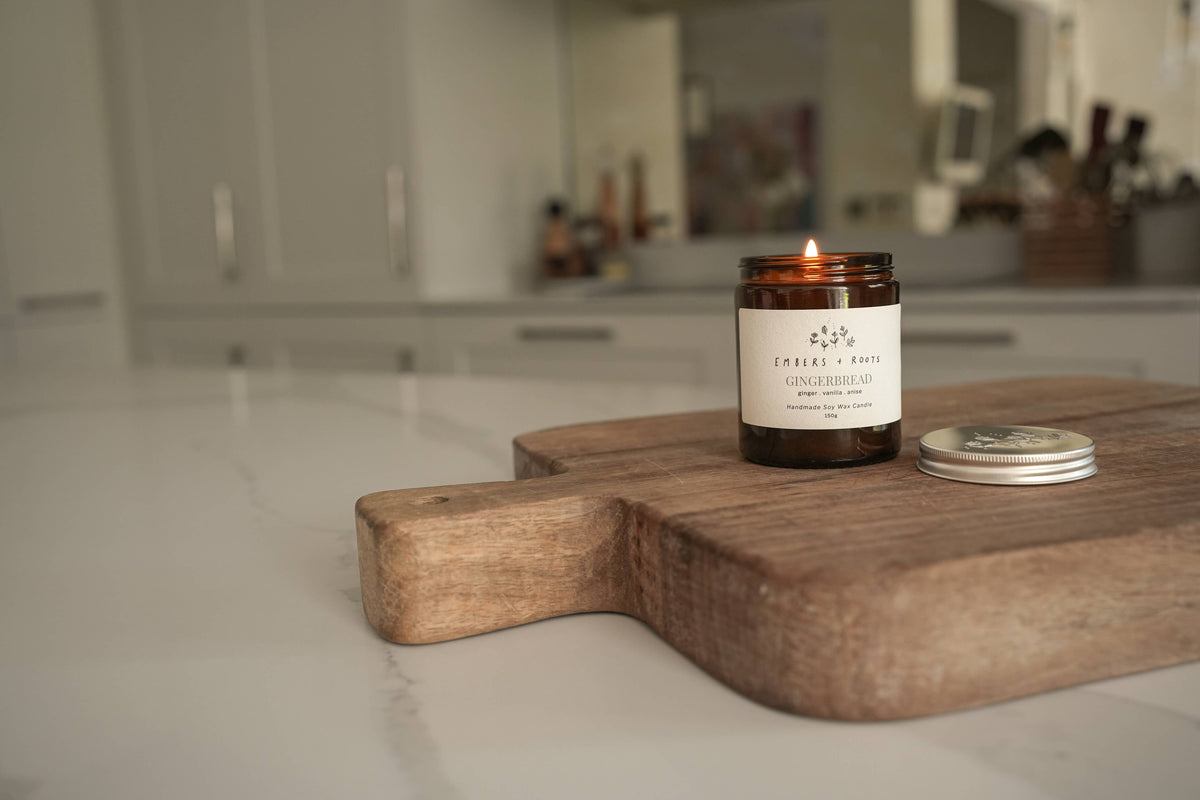Embers & Roots Gingerbread candle displayed on a wooden surface