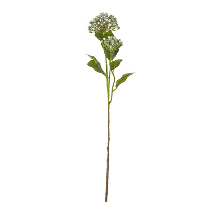 Artificial plant stem with green leaves and small white flowers on a white background