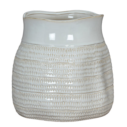 White ceramic pitcher with textured design on a white background