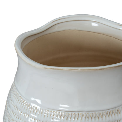 Close-up of a white ceramic vase with textured design on a white background