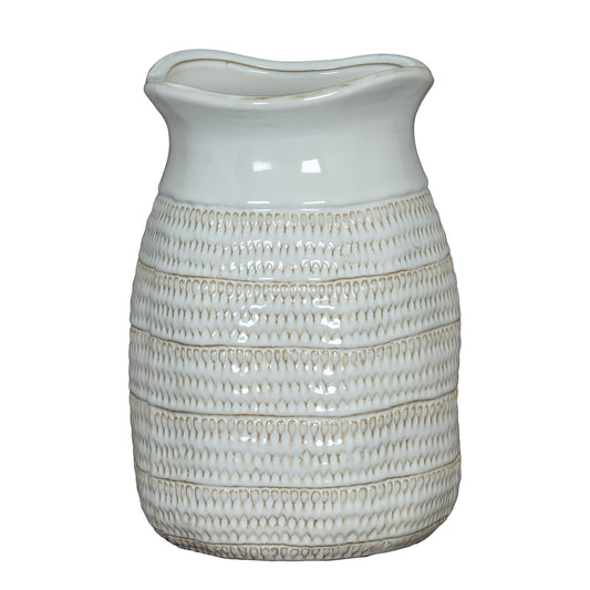 White ceramic pitcher with textured design on a white background