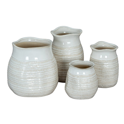 Set of four textured ceramic vases on a white background
